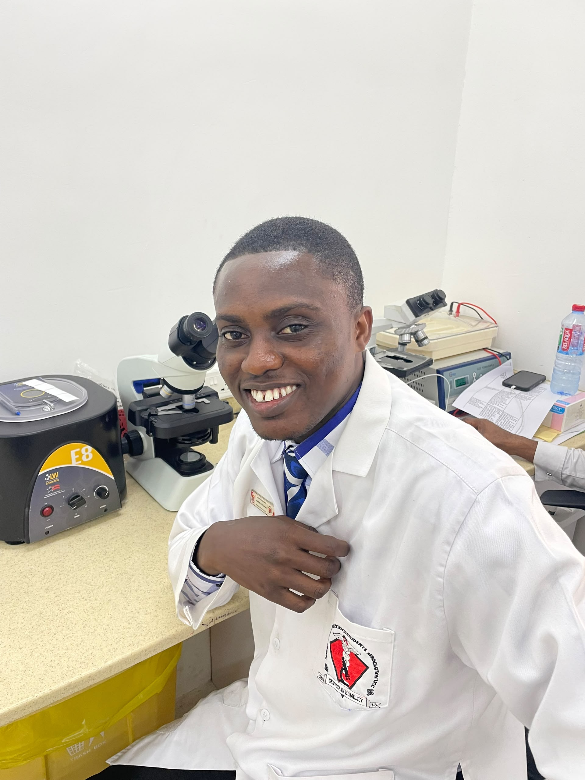 First Class Laboratory staff member at a microscope